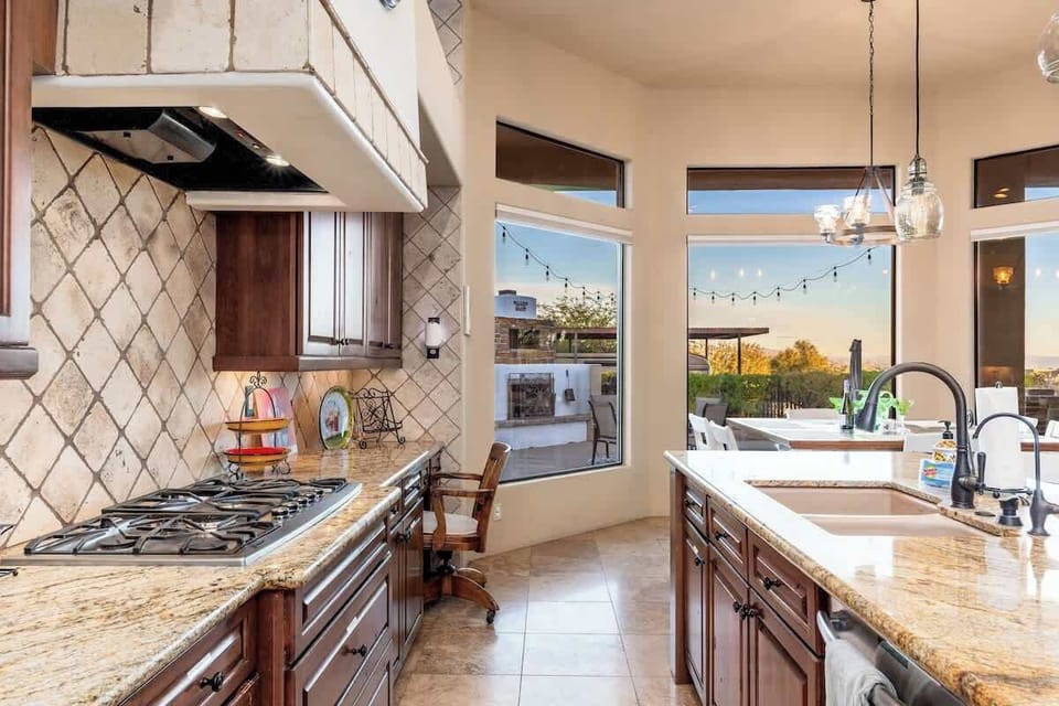 Step into a gourmet kitchen where your culinary dreams come alive, with granite counters, professional-grade appliances, and windows framing serene outdoor views that inspire every meal you create.
