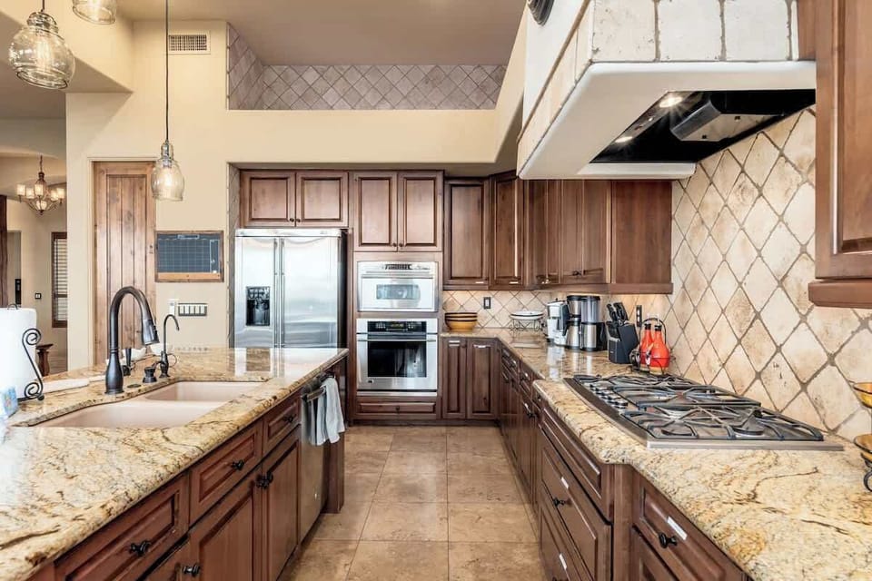 Your gourmet kitchen awaits with granite counters, stainless appliances, and a gas range—perfect for preparing memorable meals during your stay.