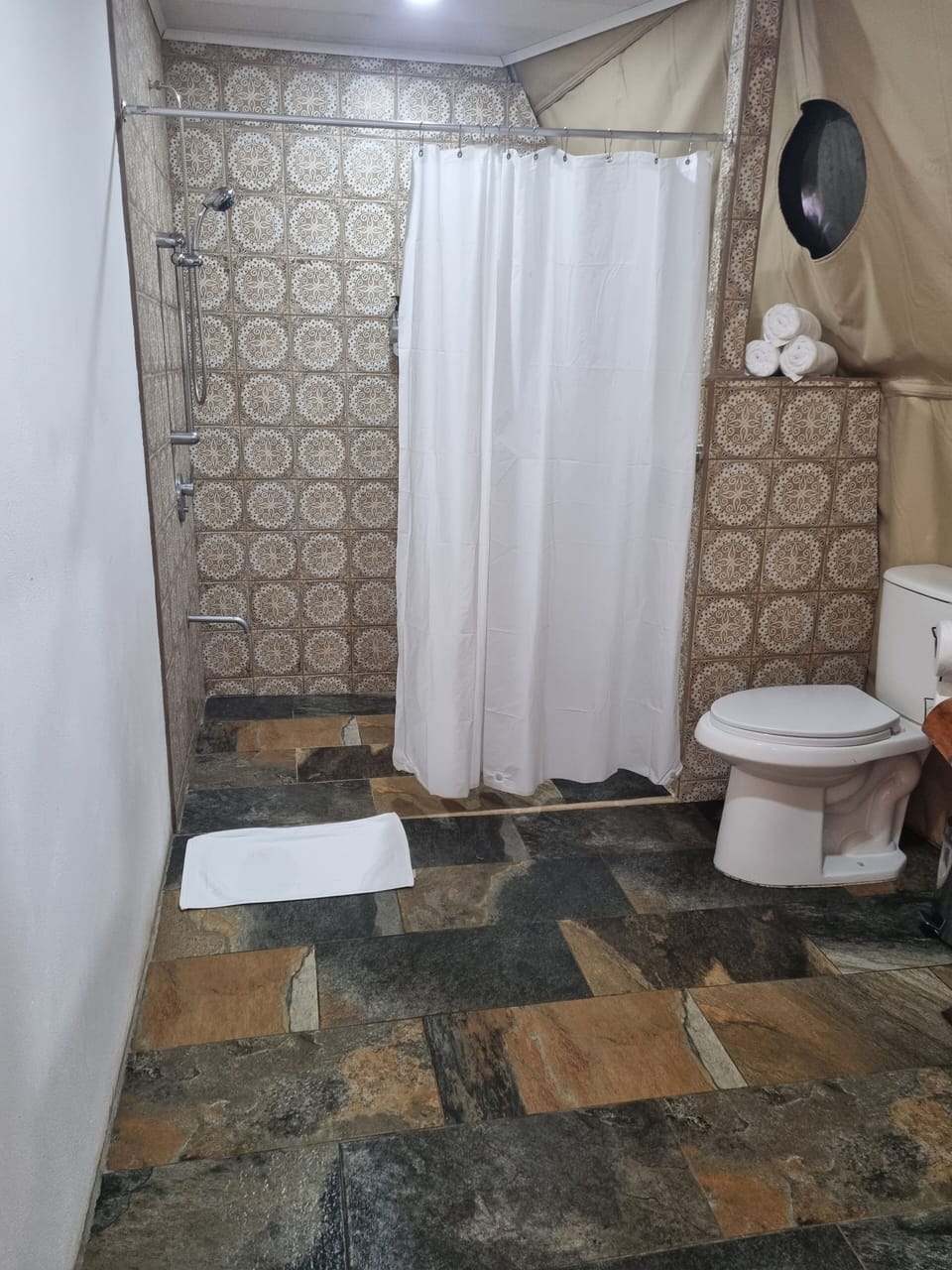 Luxury Tent, River View | Bathroom | Shower, towels, soap, shampoo