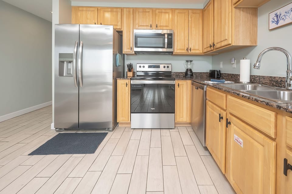 Kitchen featuring all stainless steel appliances, blender and Keurig