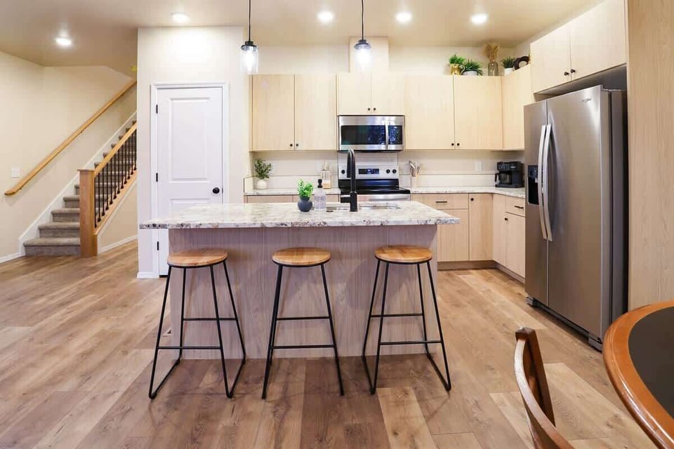 Modern kitchen with island seating and room for group meals

