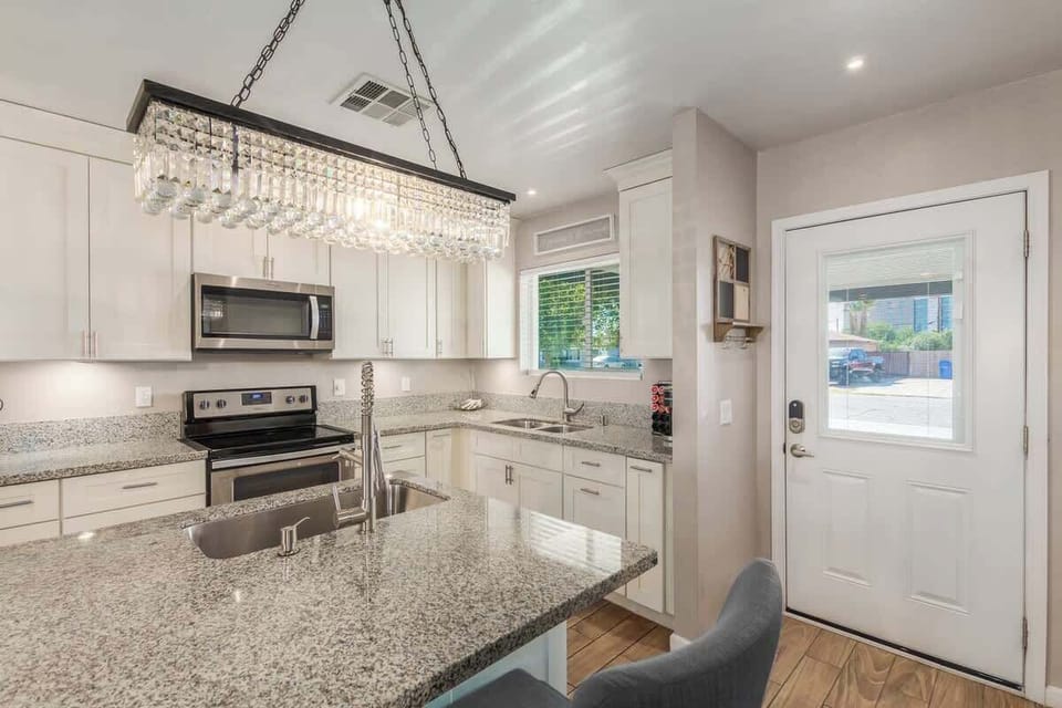 Functional kitchen with granite countertops and new appliances.