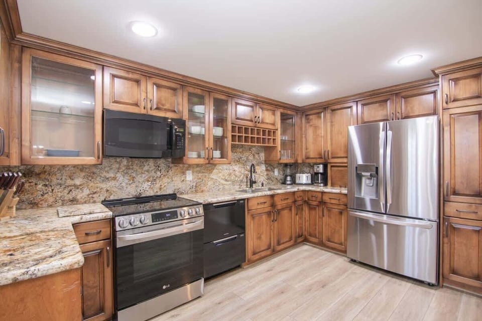 Modern kitchen equipped with top-of-the-line appliances, marble countertops, and all your cooking essentials.
