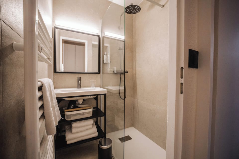 Shower, rainfall showerhead, hair dryer, towels