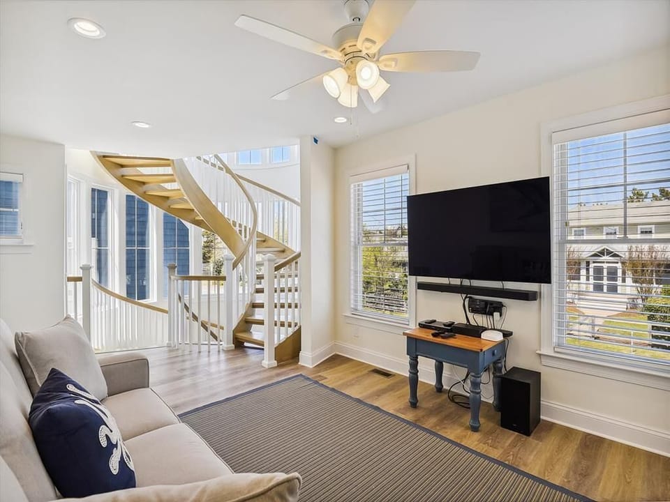 Spacious living room on the first floor with natural light and comfortable seating, perfect for family gatherings or movie nights.