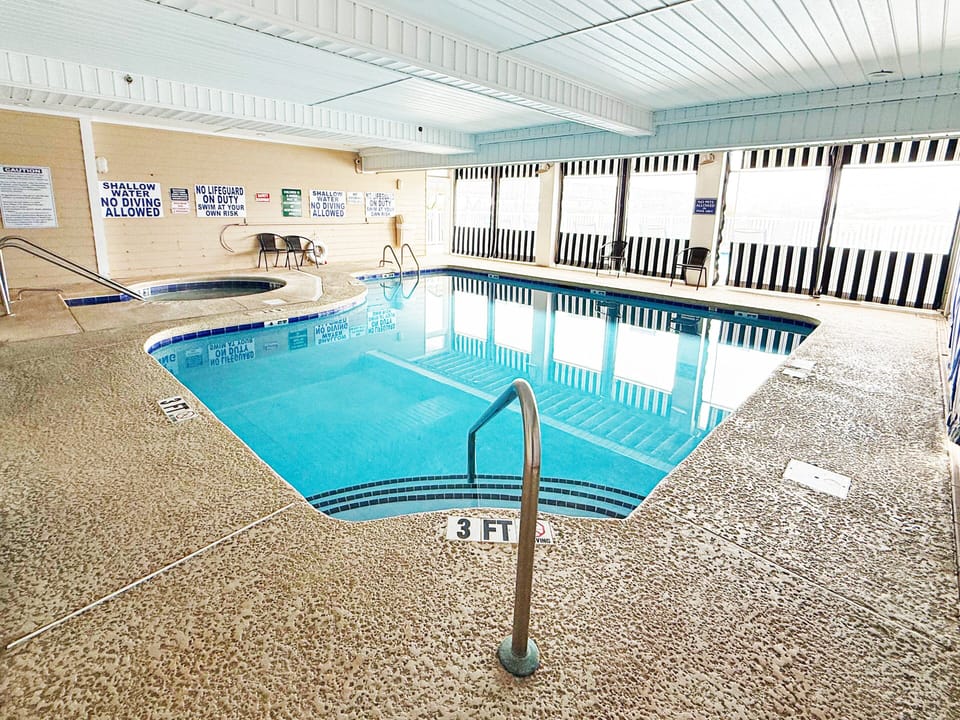 Indoor Pool - Indoor pool and hot tub area at the property, offering an additional option for swimming and relaxation.