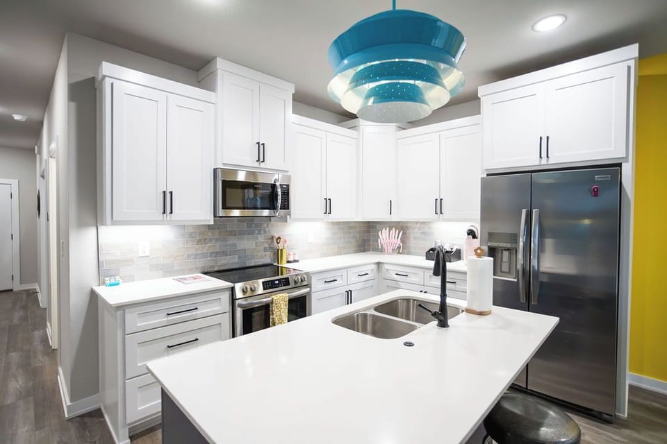 Fully stocked kitchen with pots, pans, plates, cups, etc