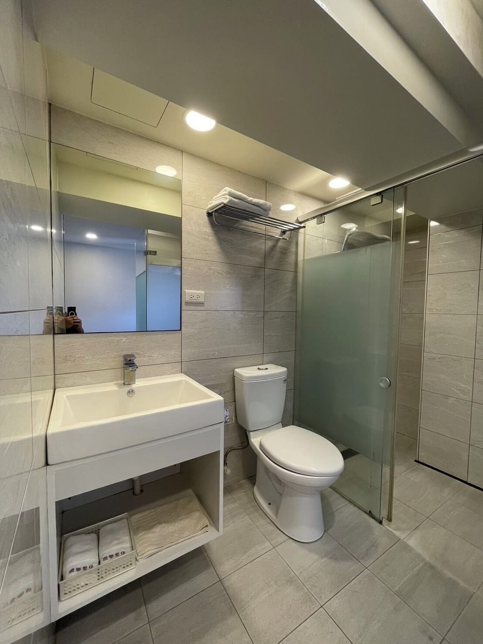 Shower, hair dryer, slippers, towels