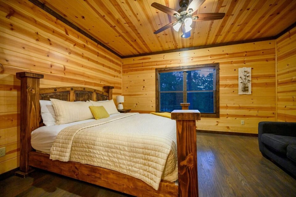 Wake up to those big blue-shuttered windows framing the forest, wood beams overhead, and a solid timber bed that makes you feel like you`re sleeping in your own private lodge.