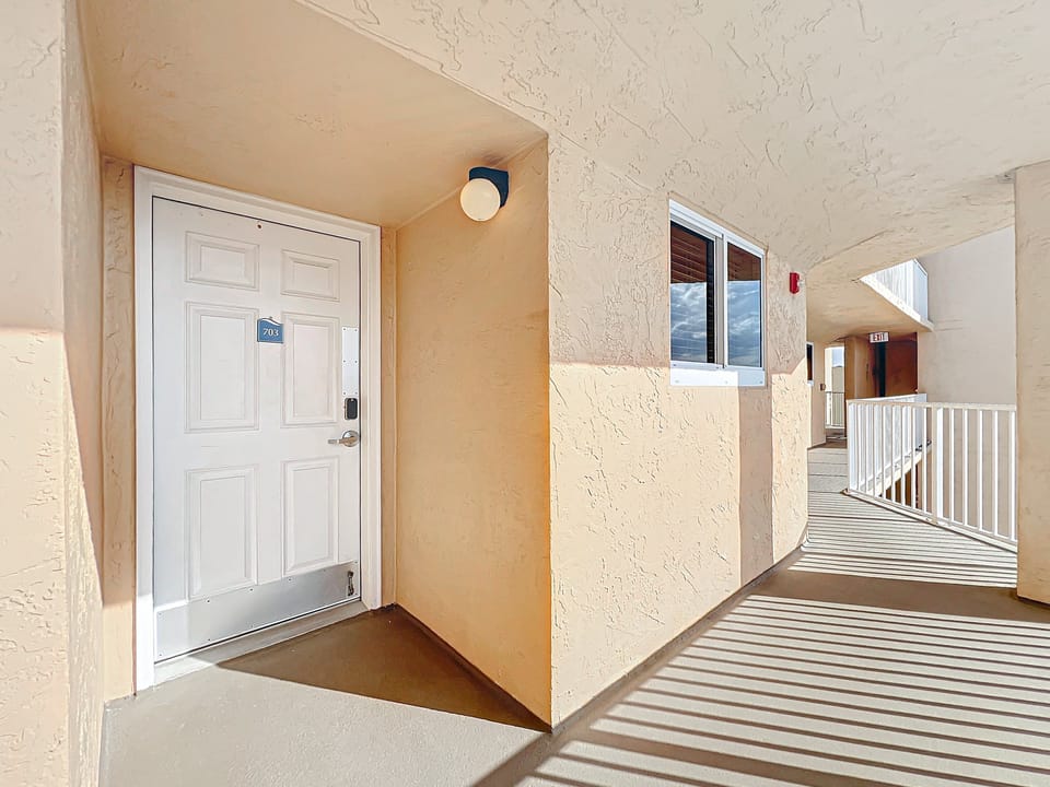 Step into your beachside retreat through this bright and inviting entry, leading to a relaxing haven with stunning ocean views and amenities.