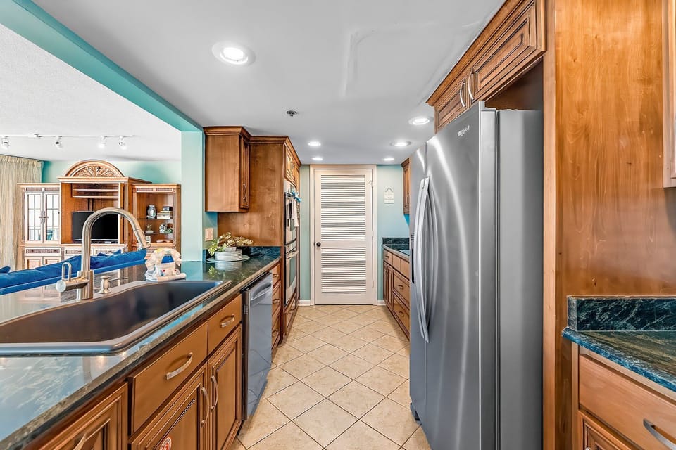 The fully equipped kitchen features granite countertops, stainless-steel appliances, including double ovens, and has everything you need to prepare meals for family & friends.