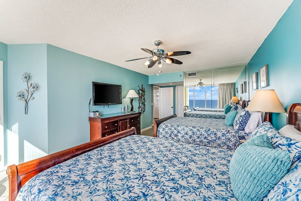 The second gulf front bedroom offers 2 Queen sized beds, its own television, and access to the balcony.