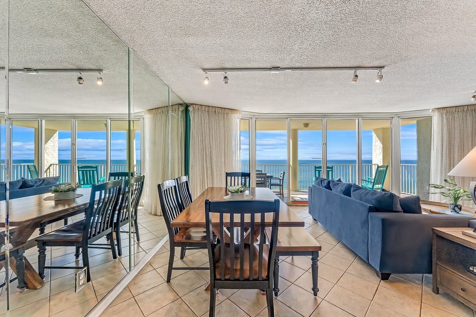 There is a dining table, perfect for enjoying a meal or playing a game, as well as additional breakfast bar seating.