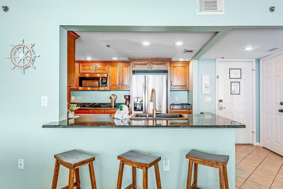 There is a dining table, perfect for enjoying a meal or playing a game, as well as additional breakfast bar seating.