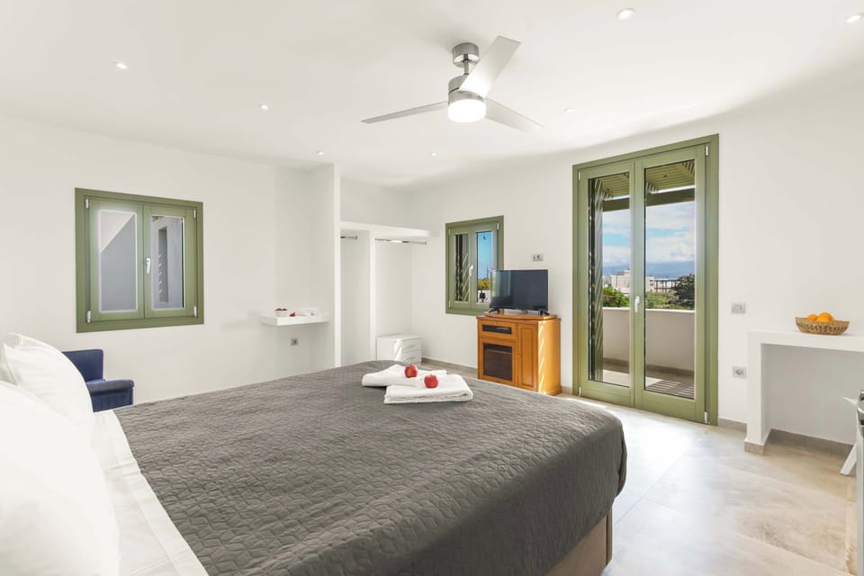 edroom Interior – Large Windows and Shutters
Natural light enhances the Cycladic white and soft neutral design.