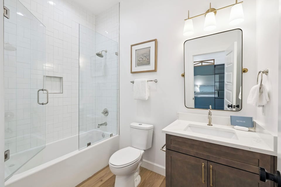 Freshen up in this bright bathroom with a spacious tub-shower combo, sleek vanity, and modern fixtures designed for your comfort.