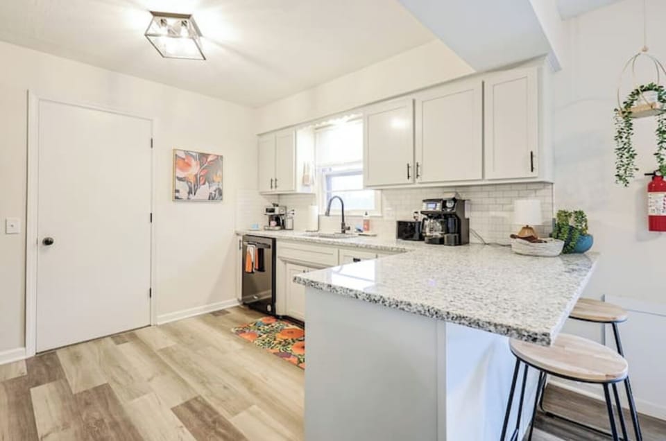 Bright kitchen with stone counters and full cookware set