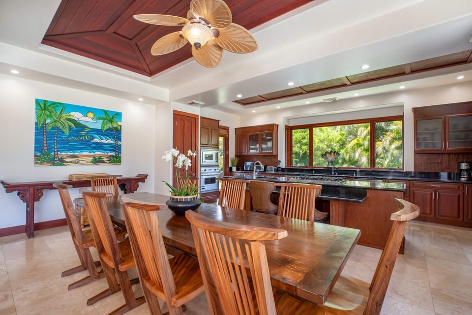 Gather for meals in this open-concept dining room with garden views and island-style charm.