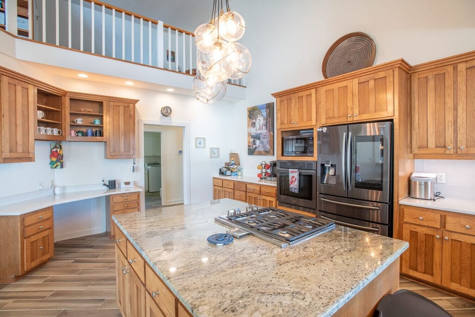 Well-equipped chef’s kitchen with large island, modern appliances, and ample prep space