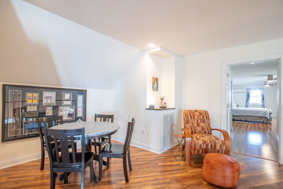 Spacious upstairs landing with dining nook and cozy seating, ideal for relaxing or gathering