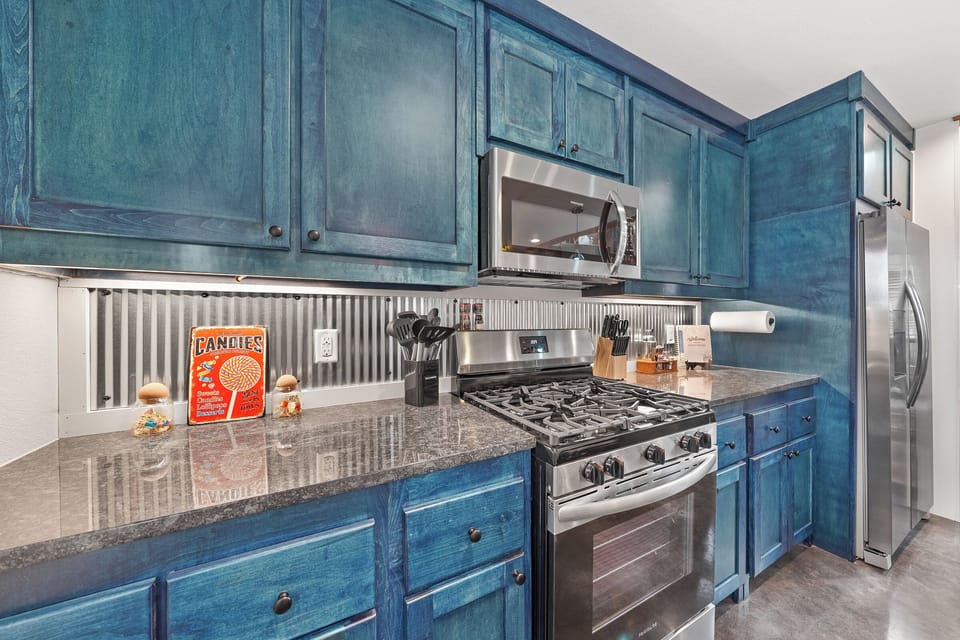 Modern kitchen with bold blue cabinets and stainless appliances