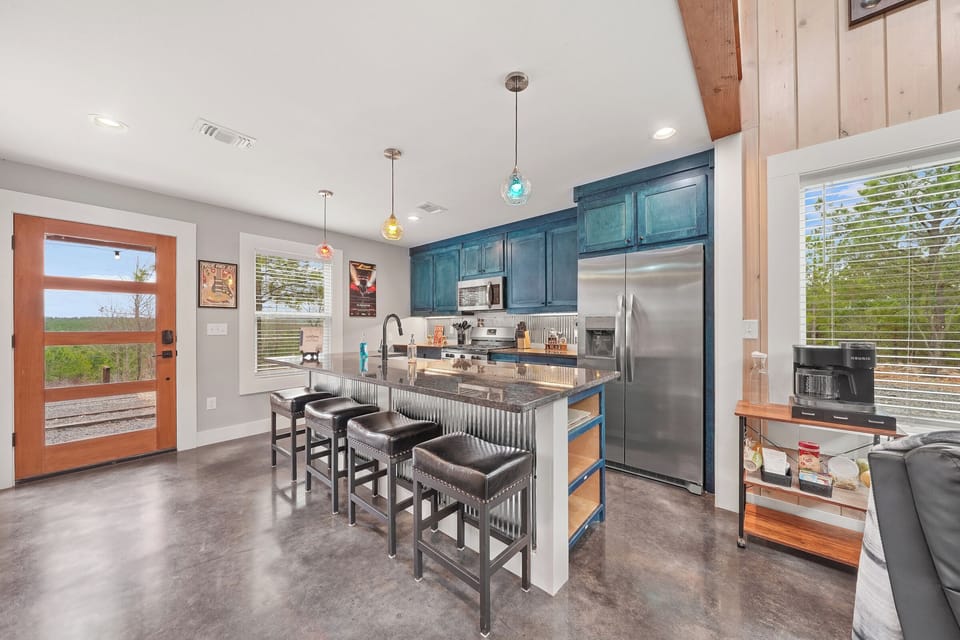 Modern kitchen with bold blue cabinets and stainless appliances