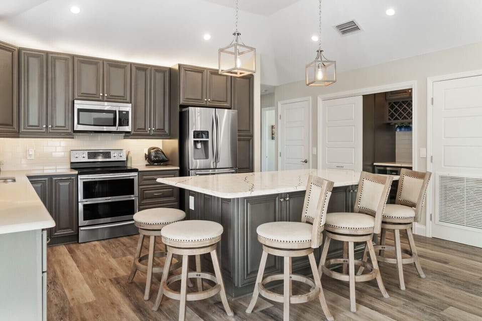 Fully equipped with modern appliances, ample counter space, and a large island for family meals.