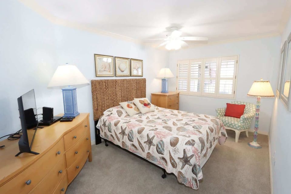Guest Bedroom 2: Queen bed sharing access to the renovated hallway bathroom with single vanity and shower/tub combo.