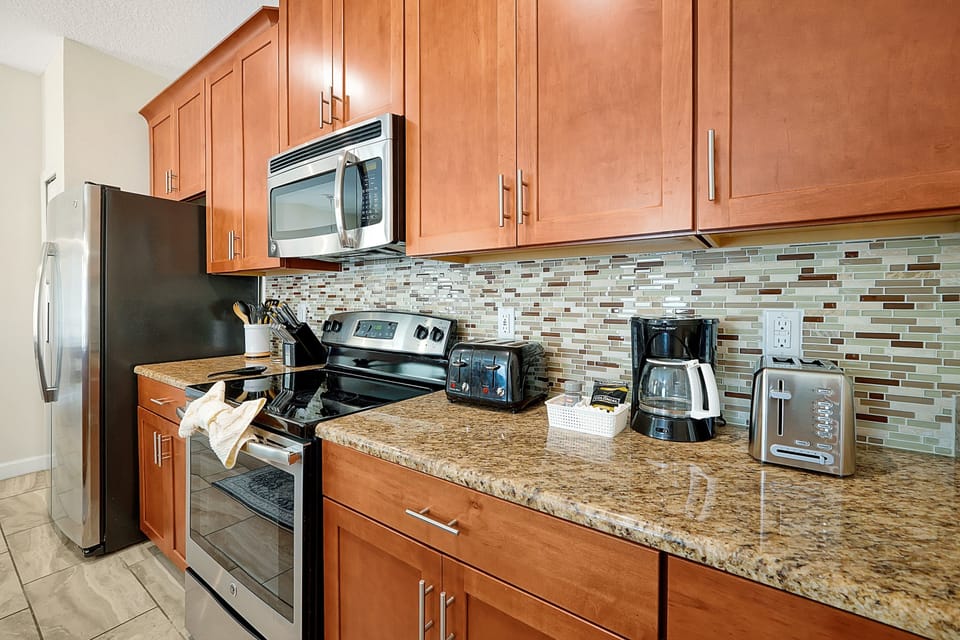 A chef's delight! Our fully-equipped kitchen features modern stainless steel appliances, a beautiful backsplash, and everything you need to prepare meals easily.