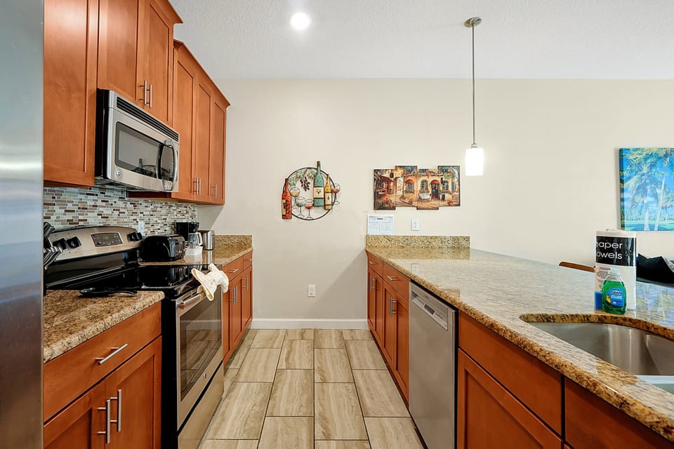 Spacious granite countertops. With ample counter space and a breakfast bar, the kitchen is perfect for quick meals or socializing while you cook. Fully stocked for your convenience.
