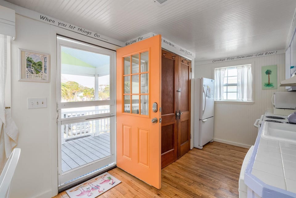 Entry door into Island Dog kitchen. There is a deck outside with seating.