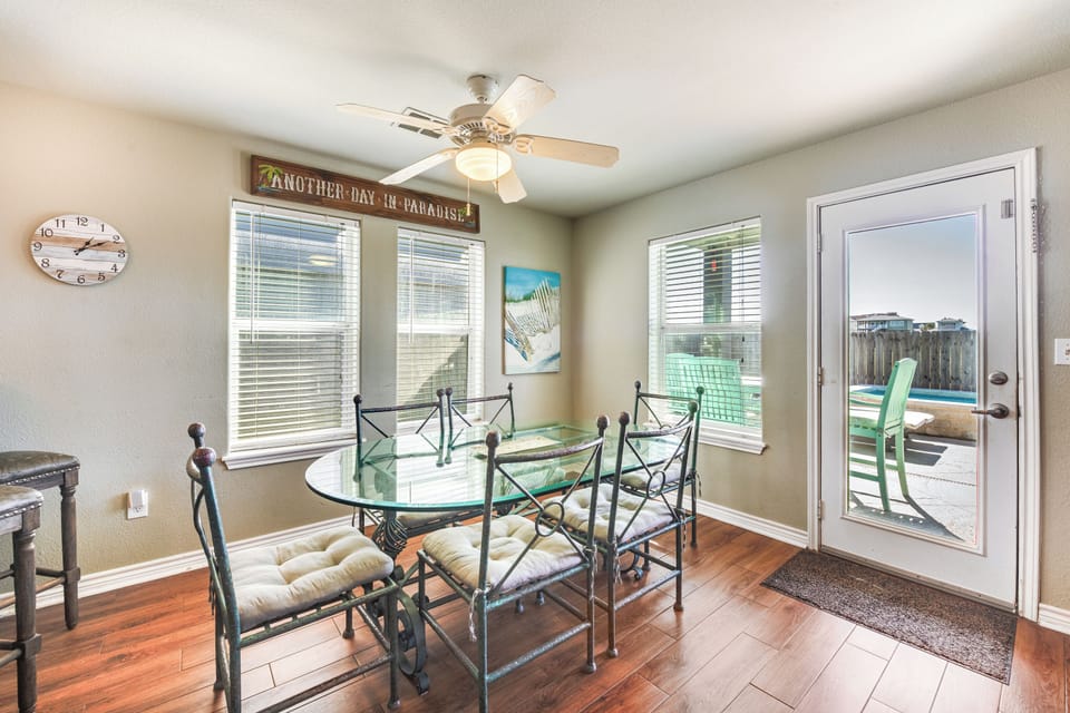 Gather for meals in your bright dining space, where warm hardwood floors and tropical decor create the perfect setting for memorable conversations.