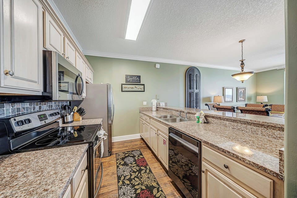 The fully equipped kitchen features granite countertops, stainless-steel appliances, and has everything you need to prepare meals for family & friends.