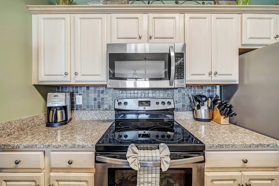 The fully equipped kitchen features granite countertops, stainless-steel appliances, and has everything you need to prepare meals for family & friends.