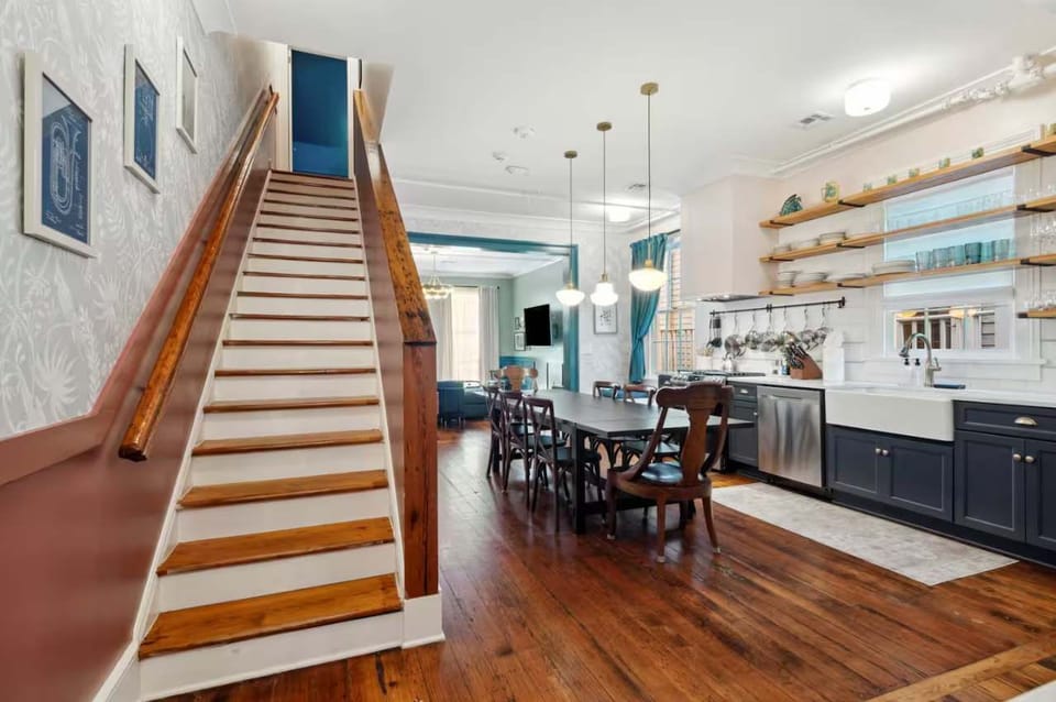 View of the kitchen with the staircase leading to the large upstairs bedroom.