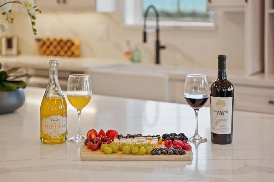 Kitchen island setup with wine, charcuterie display, and modern coastal entertaining space in this beachfront Galveston home.