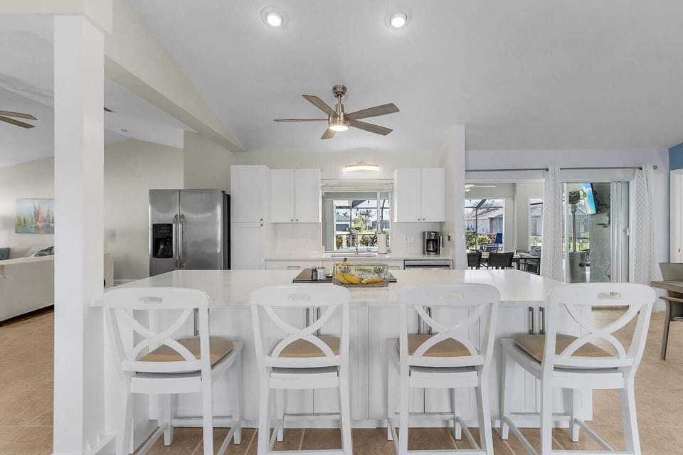 The spacious kitchen island is ideal for breakfast, snacks, coffee, or casual conversation while cooking.