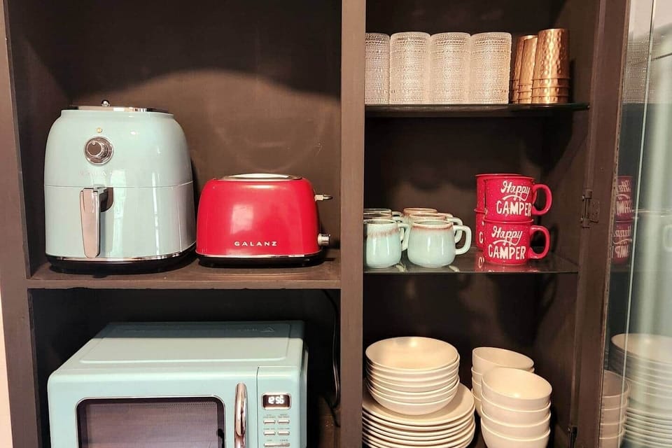 Air Fryer, toaster, microwave and all the dinner/glassware you need! There's even a set for the kids. Below is silverware, bowls and pots & pans.