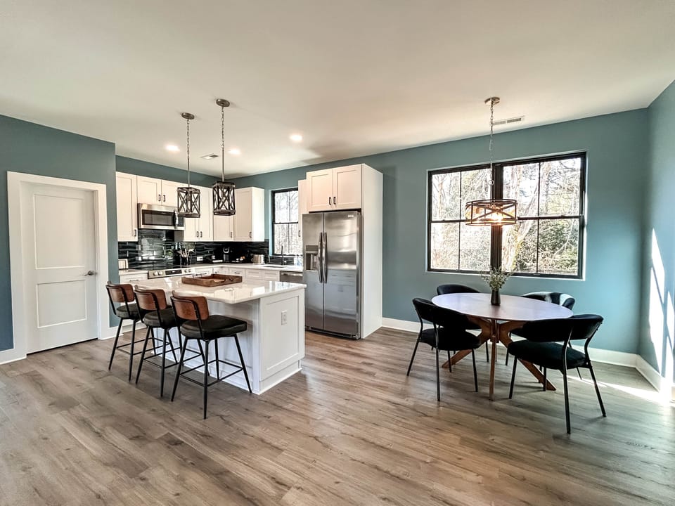Full kitchen with modern amenities and island with seating.
