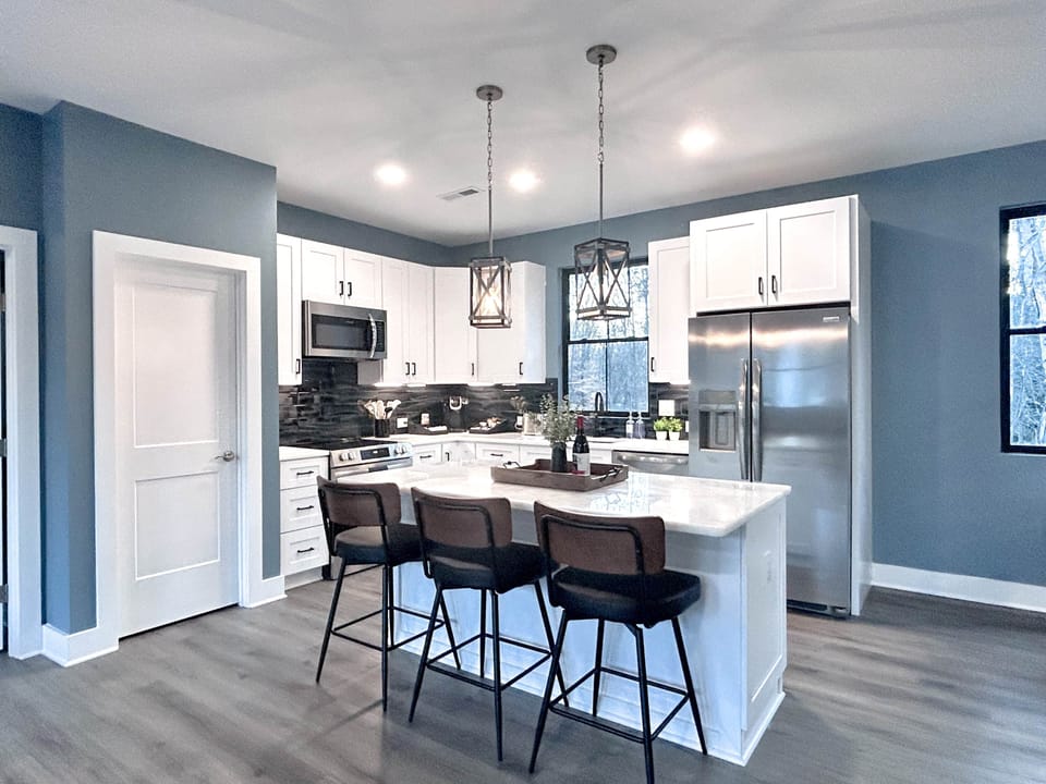 Full kitchen with modern amenities and island with seating.