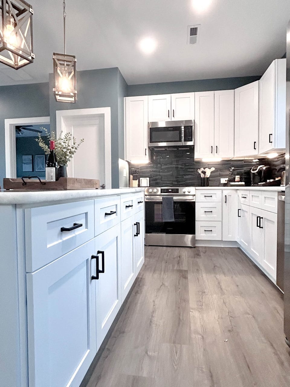 Full kitchen with modern amenities and island with seating.