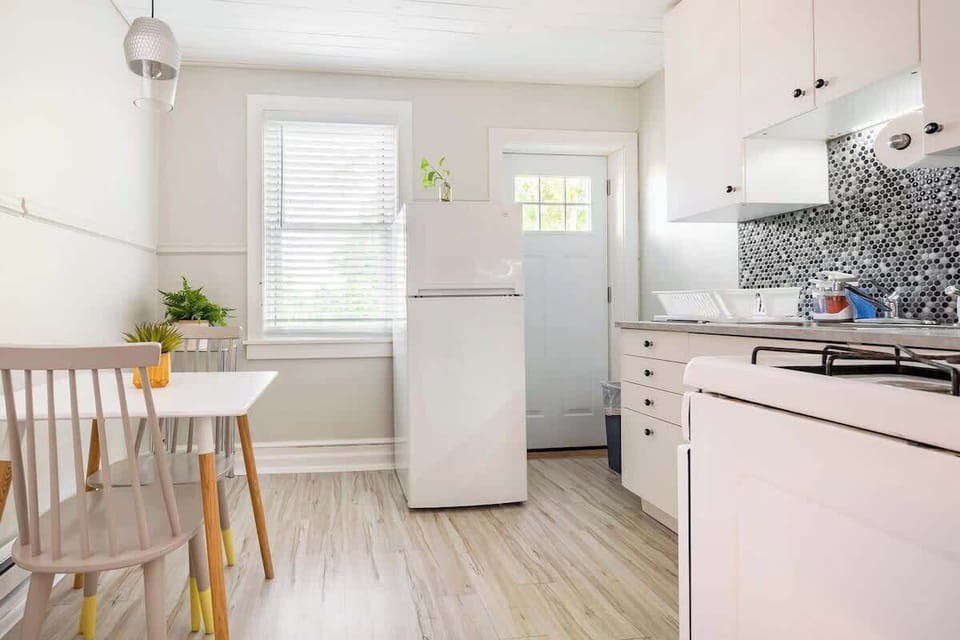 Brand new renovated eat in kitchen with shiplap ceiling, bright LED lighting and brand new floors you could eat off of. 