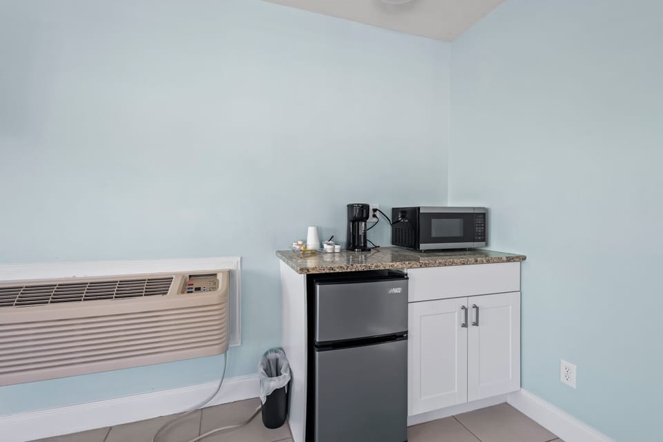 Large spacious room on the 2nd Floor of the Cove Building, features private balcony with a partial ocean view and a work station for our traveling guests.
