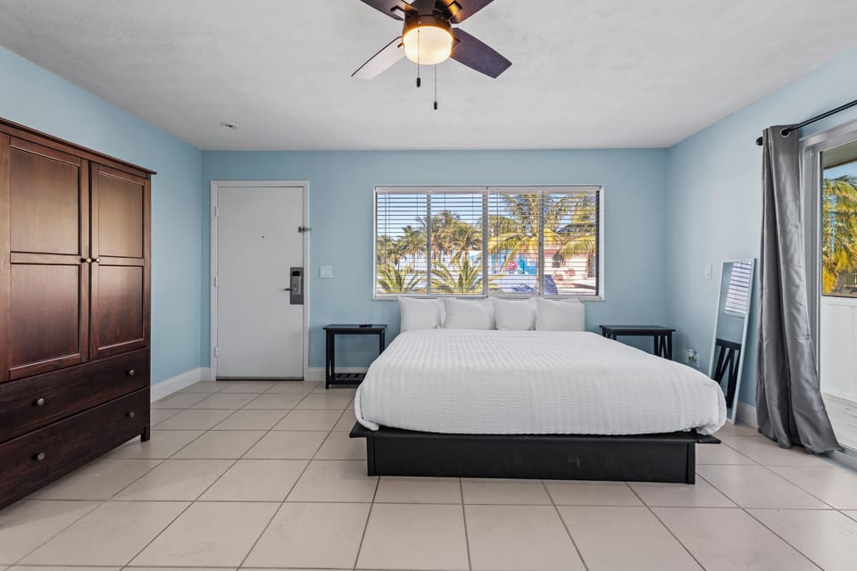 Large spacious room on the 2nd Floor of the Cove Building, features private balcony with a partial ocean view.