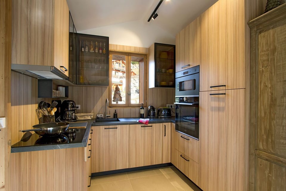 A fully equipped kitchen with warm wooden finishes, offering a welcoming space to prepare delicious meals after a day of adventure.
