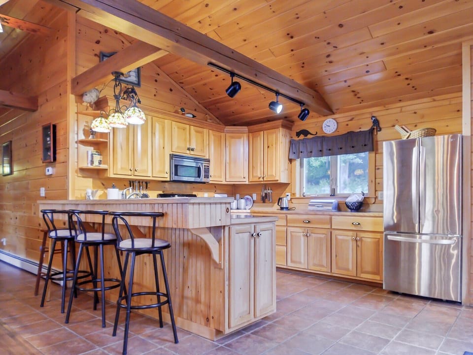 Full kitchen with bar seating for three