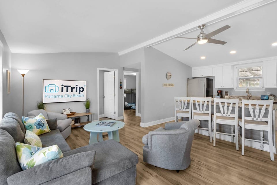 This modern vacation rental boasts a cozy living area with plush seating and vibrant accents.