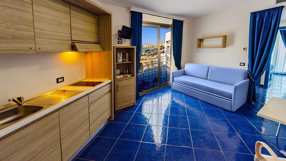 Suite, Partial Sea View | Private kitchen | Fridge, microwave, stovetop, cookware/dishes/utensils