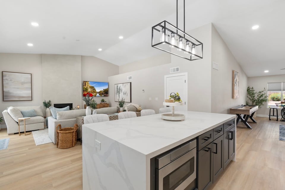Open and bright living room with a 70-inch Smart TV and ample seating.