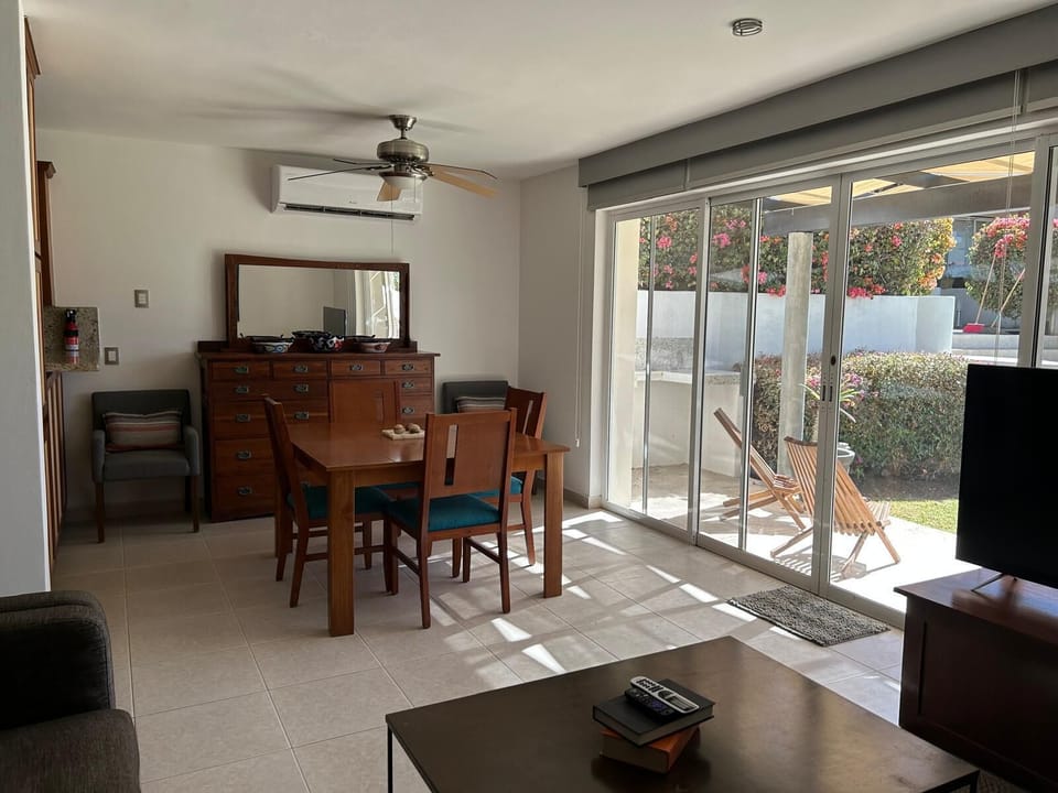 Bright and inviting living area with large windows that fill the space with natural light, creating a warm and welcoming atmosphere.